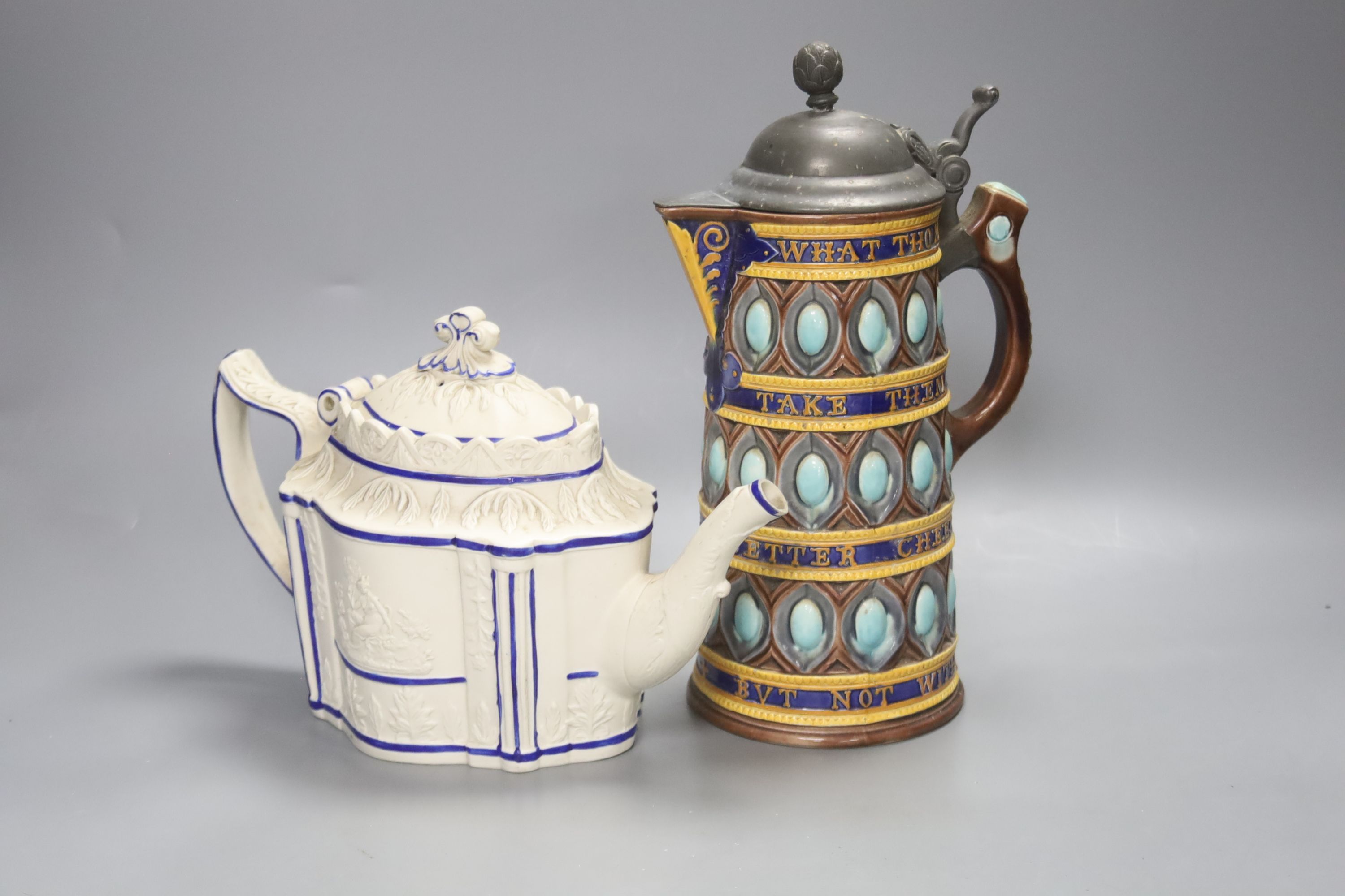 A Wedgwood majolica motto jug, 27cm high and a Regency white stoneware teapot and cover